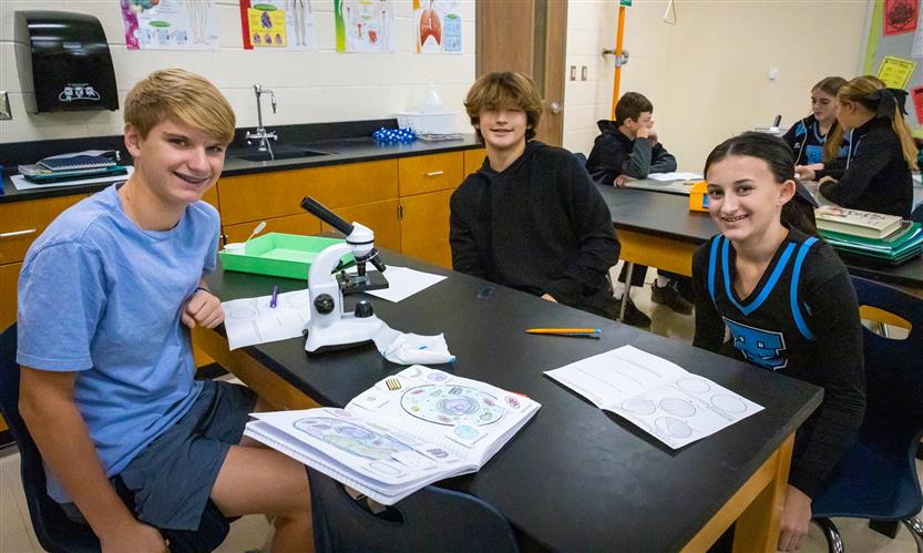 Students use microscopes in science class